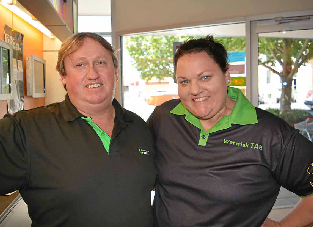CUP FEVER: Warwick TAB staff Darren Zealley and Kelly Zealley ready to help punters place their winning bets for the Melbourne Cup yesterday.